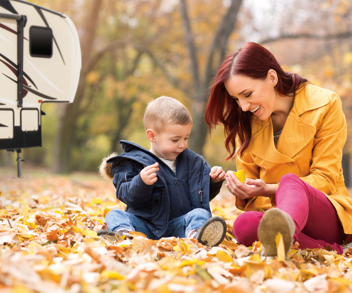 2018 Sportsmen Fifth Wheel with Mother and Son Exploring Fall Leaves