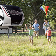 2019 KZ RV Venom V-Series V3517DK Fifth Wheel Toy Hauler with Family Playing Outdoors