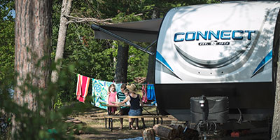 2020 KZ RV Connect C332BHK Travel Trailer with family at campsite