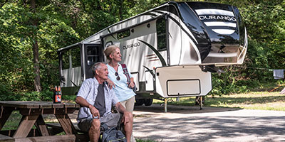 2020 KZ RV Durango D333RLT Fifth Wheel with couple at campsite