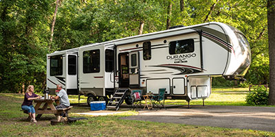2020 KZ RV Durango Gold G391RKQ Fifth Wheel with couple at campsite