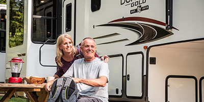 2020 KZ RV Durango Gold G391RKQ Fifth Wheel with couple at campsite