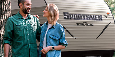 2019 KZ RV Sportsmen SE 230BHSE Travel Trailer with Couple Hiking Outdoors