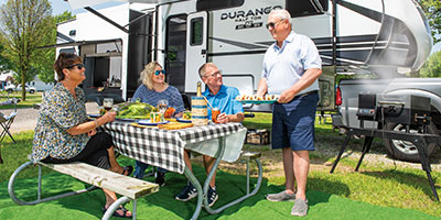 2023 KZ RV Durango Half Ton D256RKT Fifth Wheel Exterior Lifestyle Couples Cookout