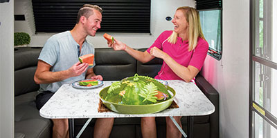 2023 KZ RV Escape E18 HATCH Travel Trailer with Couple Eating at Dinette