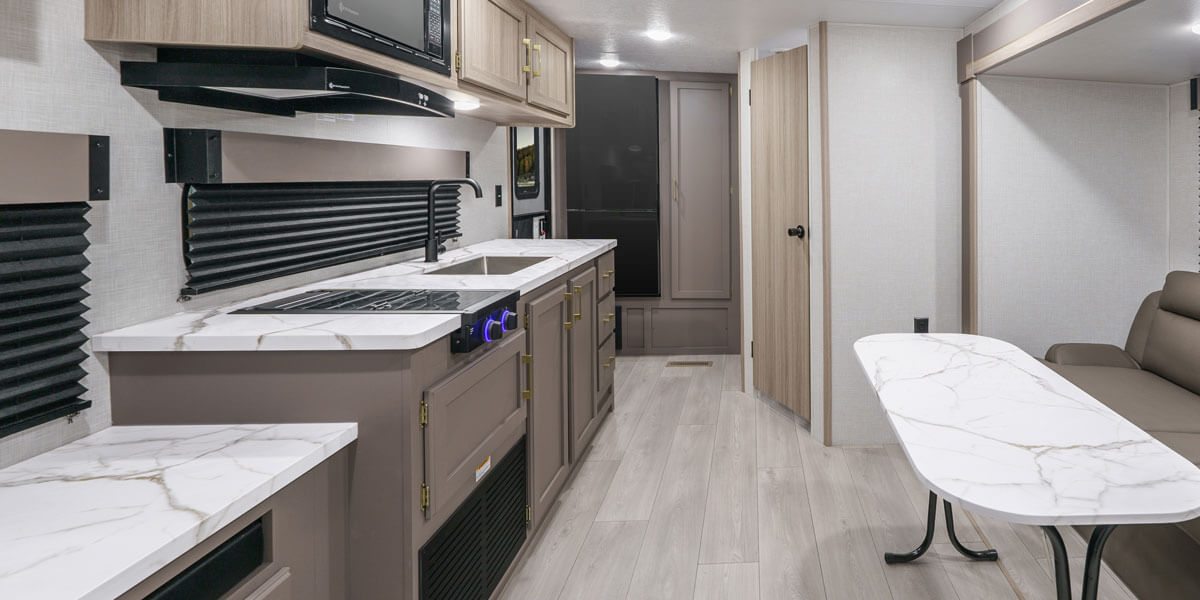 2025 KZ RV Sportsmen Select 221RKSL Travel Trailer Back to Front, Countertops, Kitchen and Sofa