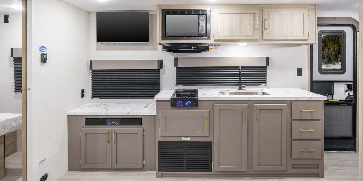 2025 KZ RV Sportsmen Select 221RKSL Travel Trailer Kitchen Microwave, TV, Oven and Cabinet Storage