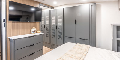 2026 KZ RV Domani DM323RL Travel Trailer Master Bedroom Entertainment Center and Dresser