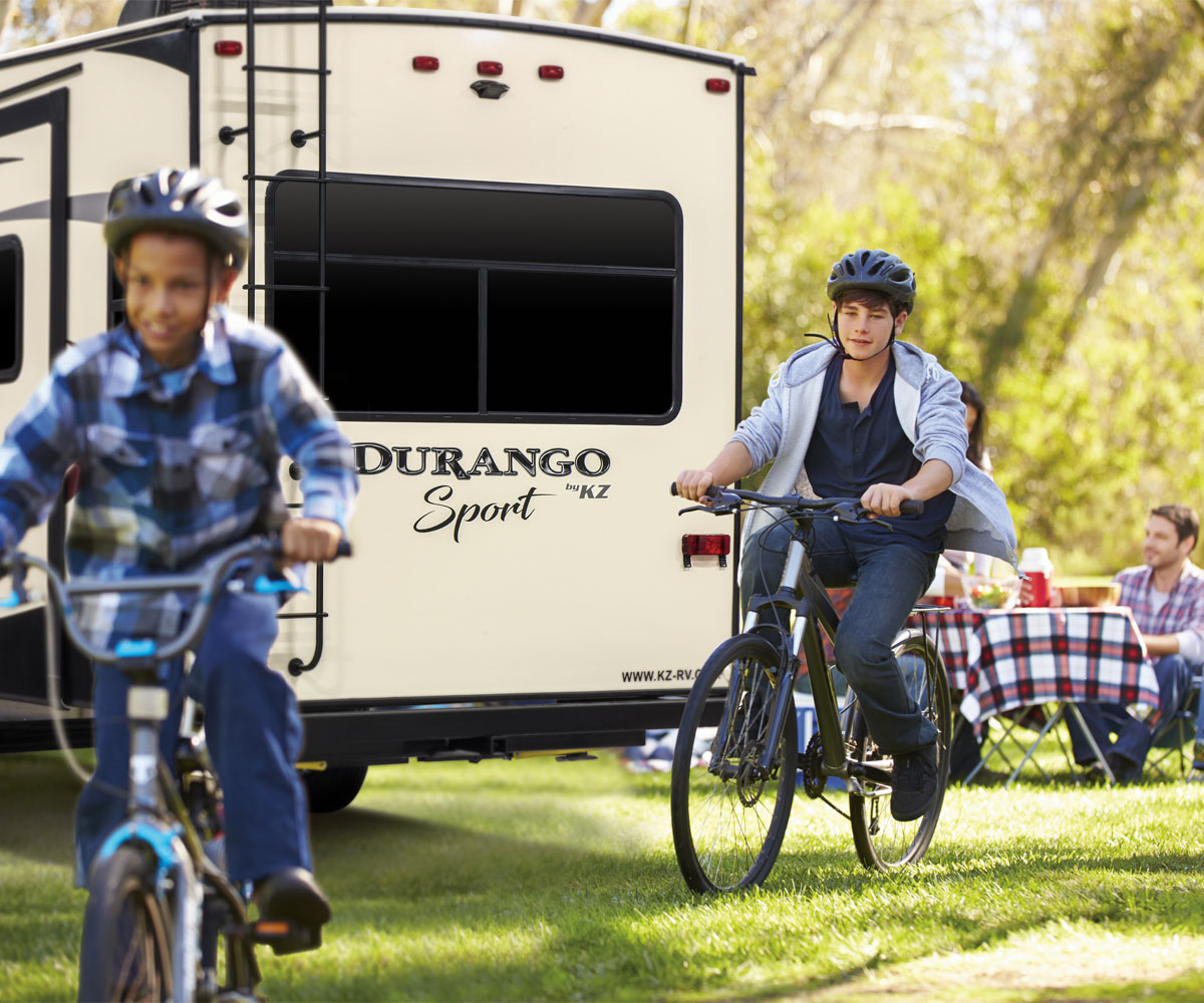 2018 Durango 1500 Sport Lightweight Luxury Fifth Wheel with Kids Riding Bikes Outdoors