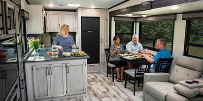 2023 KZ RV Durango Half Ton D256RKT Fifth Wheel Interior Lifestyle Couples in Kitchen