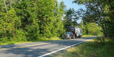 2026 KZ RV Sportster X 3411X Fifth Wheel Toy Hauler Exterior Lifestyle Driving 01