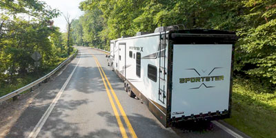 2026 KZ RV Sportster X 3411X Fifth Wheel Toy Hauler Exterior Lifestyle Driving 02