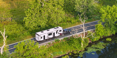 2026 KZ RV Sportster X 3411X Fifth Wheel Toy Hauler Exterior Lifestyle Driving 07