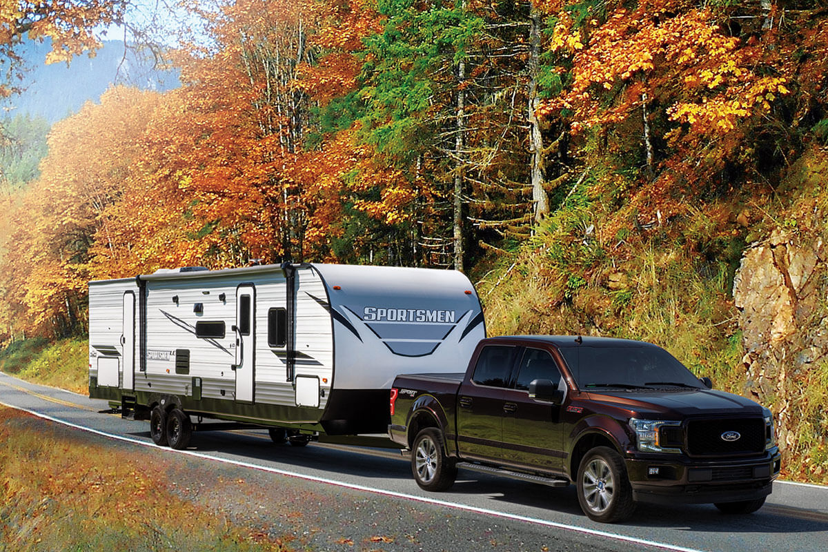 KZ RV Sportsmen LE 332BHKLE Travel Trailer Being Towed in Fall