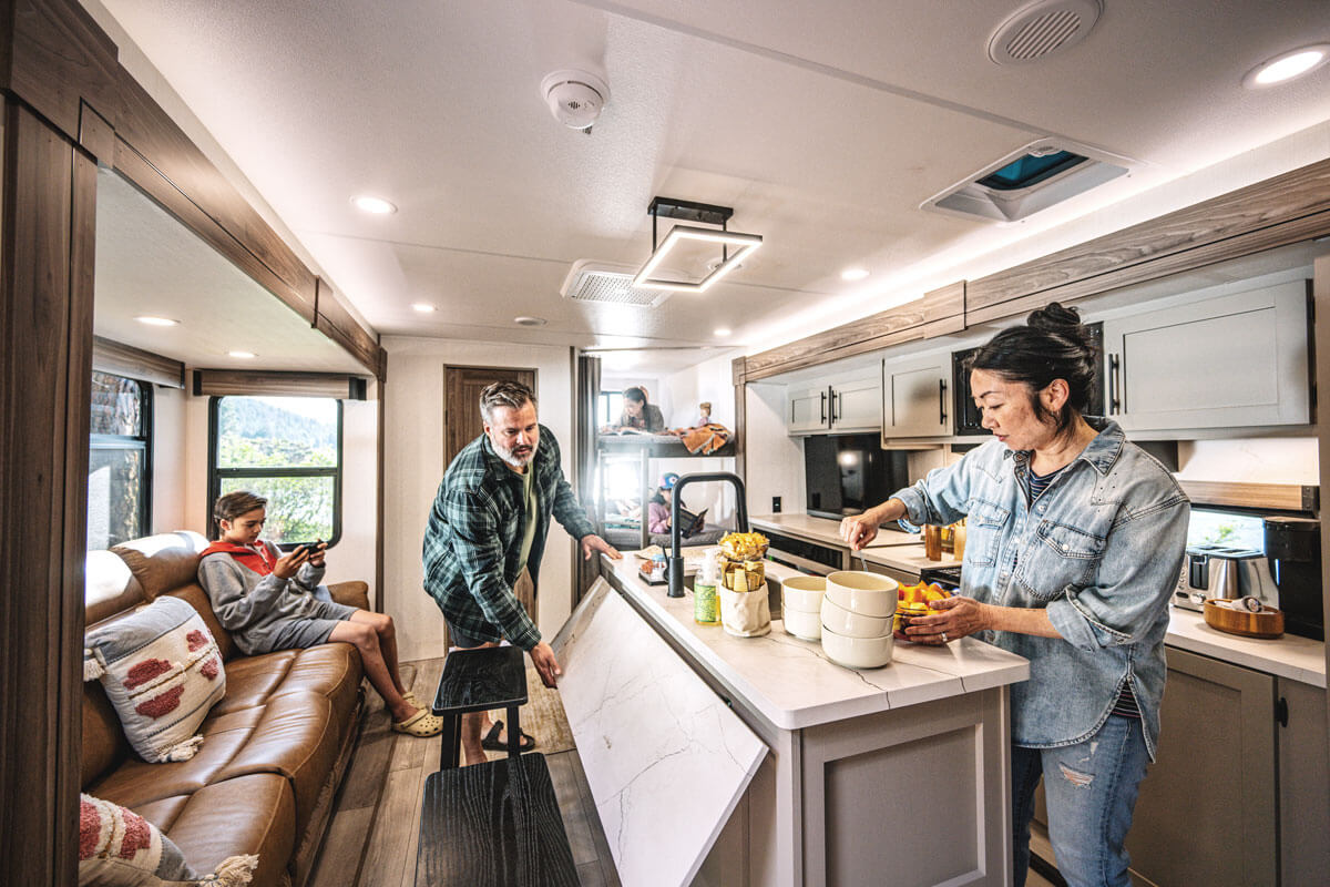 KZ RV Connect C252BH Travel Trailer with Family in Kitchen Baking